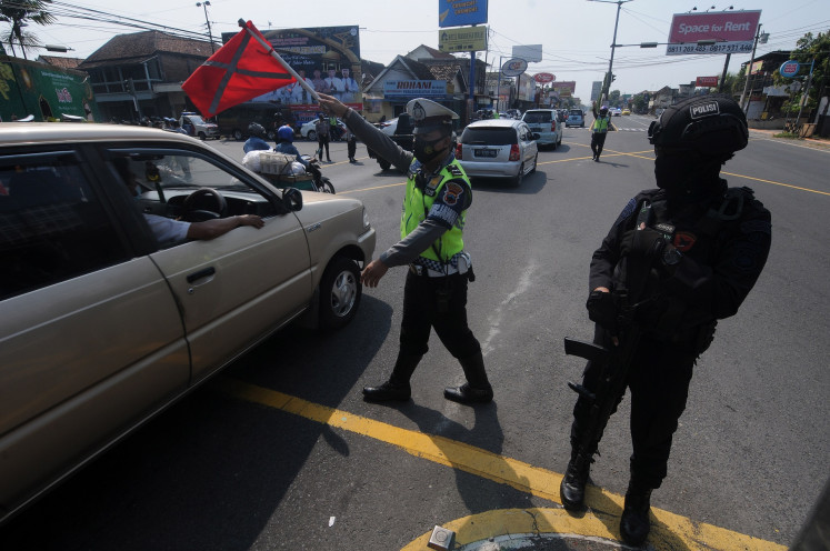 A police officer manages traffic at a checkpoint between Yogyakarta and Central Java in Prambanan, Klaten, Central Java on May 12.