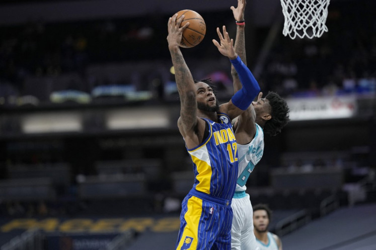 Oshae Brissett #12 of the Indiana Pacers shoots the ball against the Charlotte Hornets during the 2021 NBA Play-In Tournament on May 18, 2021 at Bankers Life Fieldhouse in Indianapolis, Indiana. 