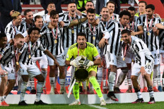 Juventus' Italian goalkeeper Gianluigi Buffon holds the winner's trophy as Juventus players celebrate winning the final of the Italian Cup (Coppa Italia) football match Atalanta vs Juventus on May 19, 2021 at the Citta del Tricolore stadium in Reggio Emilia.