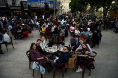 People gather at a terrace of a cafe in Marseille, southern France, on May 19, 2021, as cafes, restaurants and other businesses re-opened across France after closures during the coronavirus (Covid-19) pandemic.