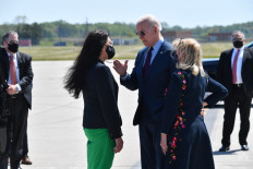 US President Joe Biden speaks with Representative Rashida Taib (D-Mich), and Representative Debbie Dingell (D-Mich)(right), as he arrives at Detroit, Metropolitan Wayne County Airport in Detroit, Michigan on May 18, 2021.
