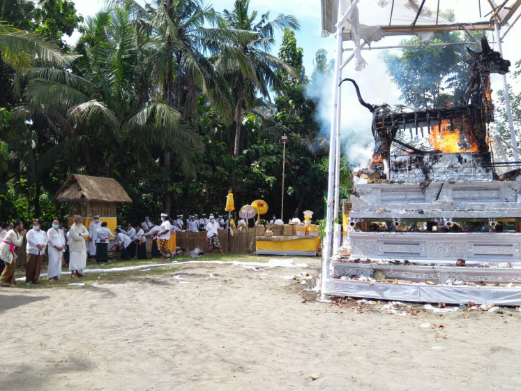 The priest's wife: The Hindu funeral ritual for a priest's wife, Ida Pedande Putu Peling Umur, who died at 93 years of age, takes place in the parking lot of the Monkey Forest sanctuary in Ubud, Bali, on March 20. Virtually everyone is wearing a mask to comply with COVID-19 safety protocol.