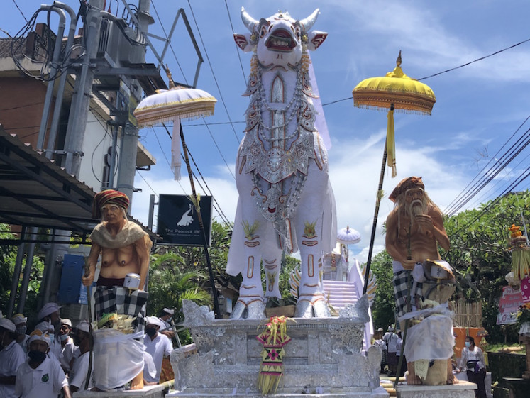 Bidding farewell: Ida Bagus Dharmayudha, 45, bids his last farewell to his grandmother, Ida Pedande Putu Peling Umur, who died at 93 years of age on Feb. 10. The cremation took place in the parking lot of the Monkey Forest sanctuary in Ubud, Bali, on March 20. 