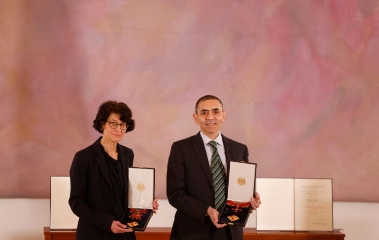 Ozlem Tureci (left) and her husband Ugur Sahin, both scientists and founders of BioNTech, pose with their orders after they were awarded the Federal Cross of Merit (Bundesverdienstkreuz) by the German President on March 19, 2021 at the presidential Bellevue Palace in Berlin. 