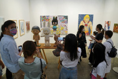 Reopened: Visitors take pictures of artworks displayed at the Art Basel in Hong Kong, China May 19, 2021. 