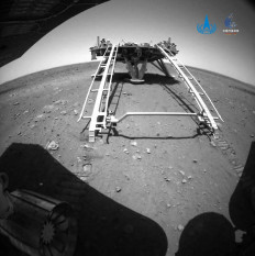 This handout photograph released on May 22, 2021 by the China National Space Administration (CNSA) shows an image taken by the rear obstacle avoidance camera of China's Zhurong Mars rover showing the landing platform of the Tianwen-1 Mars probe, after the rover drove down the ramp onto the surface of Mars. 