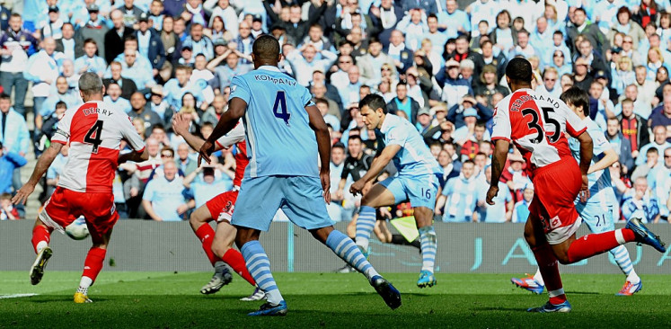 Manchester City's Argentinian striker Sergio Aguero (3rd R) scores their late winning goal during the English Premier League football match between Manchester City and Queens Park Rangers at The Etihad stadium in Manchester, north-west England on May 13, 2012. Manchester City won the game 3-2 to secure their first title since 1968. This is the first time that the Premier league title has been decided on goal-difference, Manchester City and Manchester United both finishing on 89 points.