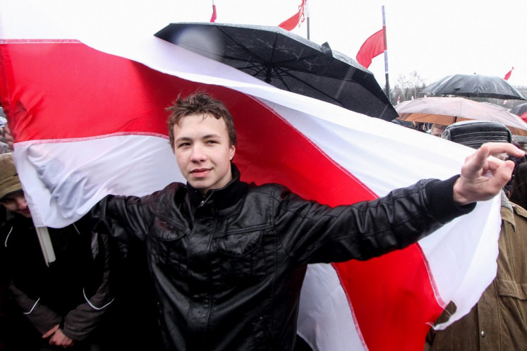 This picture taken in Minsk on March 25, 2012 shows former editor of Belarusian opposition Telegram channel '@nexta_tv' Roman Protassevitch during 'Freedom Day' rally. Belarusian opposition Telegram channel '@nexta_tv' announced on May 23, 2021 its former editor and exiled opposition activist Roman Protassevitch had been detained at Minsk airport after his flight made an emergency landing ordered by Belarus' President.