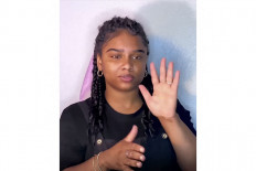 Positive influence: This image taken from her Instagram account (@itscharmay), shows social media influencer Nakia Smith as she signs in Black American Sign Language. The young African-American woman has been deaf since birth, and uses her large following on the social media app to promote her little-known dialect: Black American Sign Language.