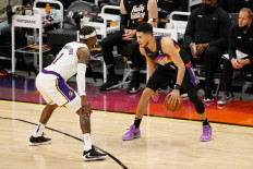 Devin Booker #1 of the Phoenix Suns handles the ball against Kentavious Caldwell-Pope #1 of the Los Angeles Lakers during the first half of Game One of the Western Conference first-round playoff series at Phoenix Suns Arena on May 23, 2021 in Phoenix, Arizona.