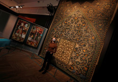 A V&A employee looks up at a full size replica of tiles from Isfahan on display at Epic Iran, an exhibition soon to open at the V&A in London, Britain, May 25, 2021.