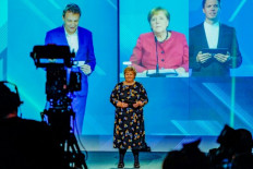 Norway's Prime Minister Erna Solberg and Chancellor Angela Merkel (C, on screen in the background) attend the official opening of NordLink, the first power connection between Norway and Germany in Oslo.