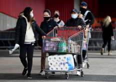 People push a trolley with their shopping at a wholesale supermarket in Melbourne on May 27, 2021, as the city was ordered into a snap week-long lockdown with officials blaming a sluggish vaccine rollout and hotel quarantine failures for another virus outbreak. 