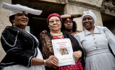 Esther Utjiua Muinjangue (left), chairwoman of the Ovaherero Genocide Foundation in Namibia, and Namibian delegation members pose on August 27, 2018 in front of Berlin's Justice Ministry during a reception on the sidelines of an official restitution of remains from people of Herero and Nama tribes. 
