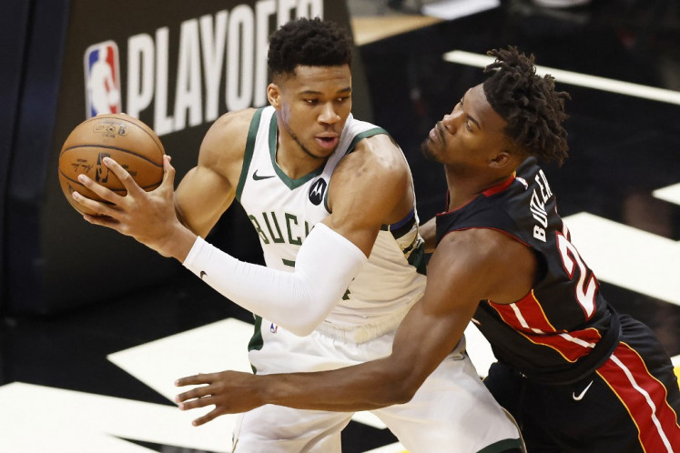 Giannis Antetokounmpo #34 of the Milwaukee Bucks is defended by Jimmy Butler #22 of the Miami Heat during the first quarter in Game Three of the Eastern Conference first-round playoff series at American Airlines Arena on May 27, 2021 in Miami, Florida.