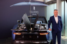 Rolls-Royce CEO Torsten Muller-Otvos speaks by a Rolls Royce Boat Tail on show at the company's Goodwood headquarters near Chichester, southwest England.