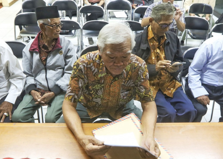 Open wounds: The chairman of the Foundation of Victims of the 1965/1966 Killings (YPKP65), Bedjo Untung, (center) and colleagues visit the National Commission on Human Rights in Jakarta on Dec. 13, 2019, to submit their finding on 346 mass graves located in Java and Sumatra that they believe are related to the state-sponsored anticommunist purge.