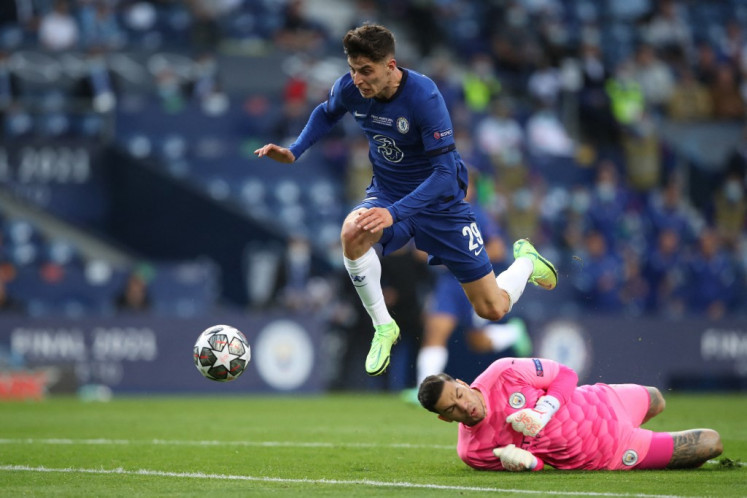 Chelsea's German midfielder Kai Havertz (L) scores a goal past Manchester City's Brazilian goalkeeper Ederson during the UEFA Champions League final football match between Manchester City and Chelsea FC at the Dragao stadium in Porto on May 29, 2021.