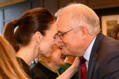 This handout picture taken and released by the Visits and Ceremonial Office of New Zealand on May 30, 2021 shows Australia's Prime Minister Scott Morrison (right) receiving a traditional 