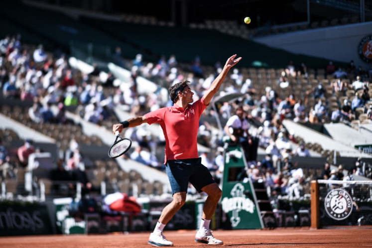 Switzerland's Roger Federer serves the ball to Uzbekistan's Denis Istomin during their men's singles first round tennis match at the Philippe Chatrier court on Day 2 of The Roland Garros 2021 French Open tennis tournament in Paris on May 31, 2021. 