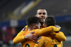  In this file photograph taken on March 24, 2021, Wales's forward Harry Wilson (L) celebrates with Wales' forward Gareth Bale (C) and Wales' defender Connor Roberts after scoring a goal during the FIFA World Cup Qatar 2022 qualification football match between Belgium and Wales at the Den Dreef Stadium in Leuven. Wales will go into Euro 2020 without their beleaguered boss Ryan Giggs, putting the spotlight on Gareth Bale's bid to silence critics who say he has lost his appetite for success. Giggs' absence following his arrest on charges of assaulting two women last year will cast a shadow over Wales during the Euro.