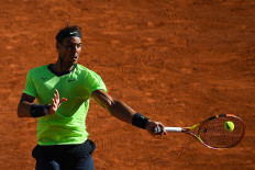 Spain's Rafael Nadal returns the ball to Australia's Alexei Popyrin during their men's singles first round tennis match on Day 3 of The Roland Garros 2021 French Open tennis tournament in Paris on June 1, 2021.
