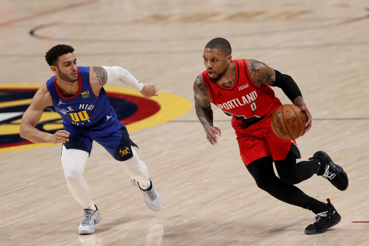 Damian Lillard #0 of the Portland Trail Blazers drives against Markus Howard #00 of the Denver Nuggets in the third period during Game Five of their Western Conference first-round playoff series at Ball Arena on June 1, 2021 in Denver, Colorado.