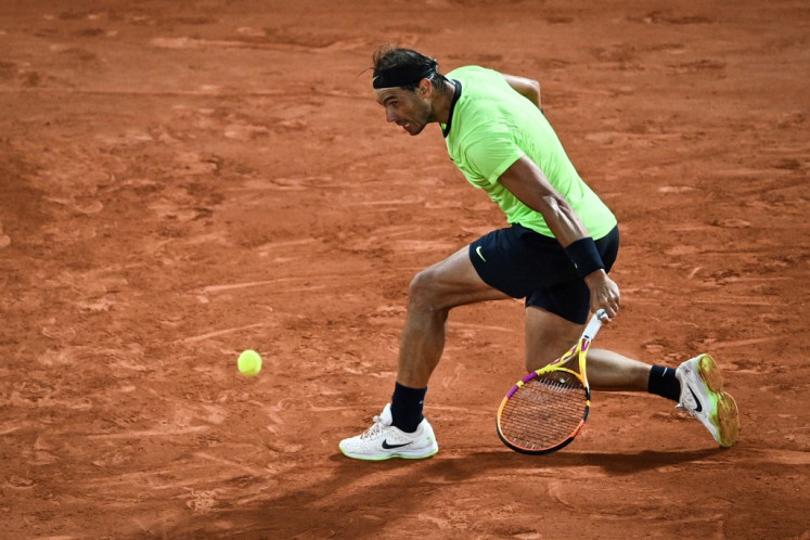 Spain's Rafael Nadal returns the ball to France's Richard Gasquet during their men's singles second round tennis match on Day 5 of The Roland Garros 2021 French Open tennis tournament in Paris on June 3, 2021.