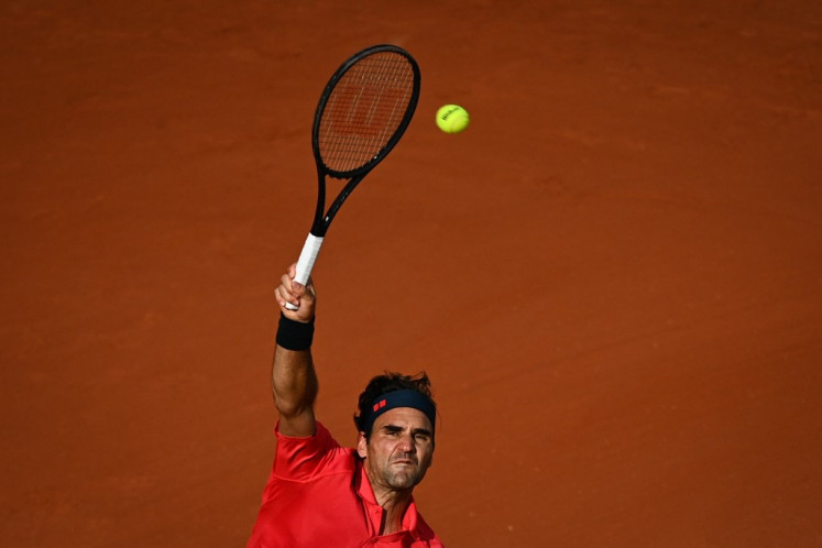 Switzerland's Roger Federer serves the ball to Croatia's Marin Cilic during their men's singles second round tennis match on Day 5 of The Roland Garros 2021 French Open tennis tournament in Paris on June 3, 2021.