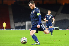 In this file photo taken on March 31, 2021, Scotland's defender Andrew Robertson crosses the ball during the FIFA World Cup Qatar 2022 Group F qualification football match between Scotland and Faroe Islands at Hampden Park in Glasgow.