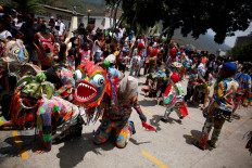 Members of Venezuelan brotherhood "Dancing Devils" pay penance during their annual Corpus Christi celebration with a call for the end of the coronavirus disease (COVID-19), in Naiguata, Venezuela.
