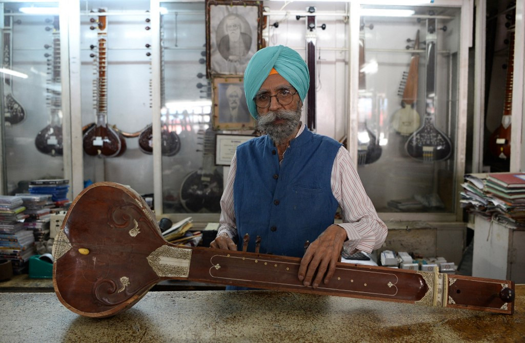In this file photo taken on June 19, 2018, Ajit Singh, owner of the music shop who fixed John Lennon's guitar and performed at George Harrison's 25th birthday party when the Beatles stayed at an ashram in nearby Rishikesh 50 years ago in 1968, poses for a picture in Dehradun. Singh, the Indian music shop owner who befriended the Beatles during their magical mystery trip in Rishikesh over half a century ago, has died aged 88.