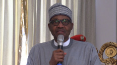 Muhammadu Buhari (left), the President of Nigeria,adresses people at the Shehu of Borno's palace in Maiduguri on February 12, 2020, to console with the people of the Auno community where over 30 lives were lost, 40 houses burnt and 18 vehicles set alight during an attack by insurgents on February 9, 2020. 