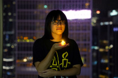 Vice-chairwoman of Hong Kong Alliance in Support of Patriotic Democratic Movements of China, Chow Hang-tung poses with a candle ahead of the 32nd anniversary of the crackdown on pro-democracy demonstrators at Beijing's Tiananmen Square.
