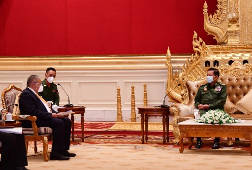This handout from the Myanmar News Agency (MNA) taken and released on June 4, 2021 shows Myanmar armed forces chief Senior Gen. Min Aung Hlaing (right) meeting with Brunei's Second Minister of Foreign Affairs Erywan Yusof (left) in Naypyidaw, Myanmar.