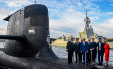 French President Emmanuel Macron (2nd left) and Australian Prime Minister Malcolm Turnbull (center) stand on the deck of HMAS Waller, a Collins-class submarine operated by the Royal Australian Navy, at Garden Island in Sydney on May 2, 2018. Macron arrived in Australia on May 1 on a rare visit by a French president with the two sides expected to agree on greater cooperation in the Pacific to counter a rising China.