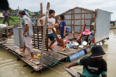 Residents demolish their floating houses on the Tonle Sap river after they were ordered to leave within one week of being notified by local authorities in Prek Pnov district, Phnom Penh, Cambodia, June 12, 2021.