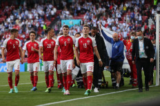 Denmark's players escort paramedics as they evacuate midfielder Christian Eriksen (not seen) during the UEFA EURO 2020 Group B football match between Denmark and Finland at the Parken Stadium in Copenhagen on June 12, 2021.
