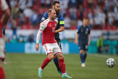 Denmark's midfielder Christian Eriksen (left) vies with Finland's midfielder Tim Sparv during the UEFA EURO 2020 Group B football match between Denmark and Finland at the Parken Stadium in Copenhagen on June 12, 2021.
