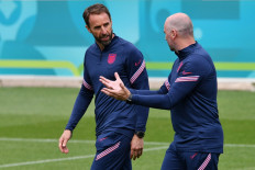England's coach Gareth Southgate (left) walks onto the pitch with a member of staff at the start of their MD-1 training session at St George’s Park in Burton-on-Trent, central England, on June 12, 2021 on the eve of their UEFA EURO 2020 match against Croatia. 