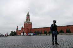 A law enforcement officer stands guard in Red Square after opposition activist Pavel Krisevich reportedly simulated shooting himself in the head in a political protest, in Moscow, Russia June 11, 2021.