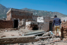 A worker walks on the roof of the National Museum in the southwestern city of Taiz, Yemen May 26, 2021.