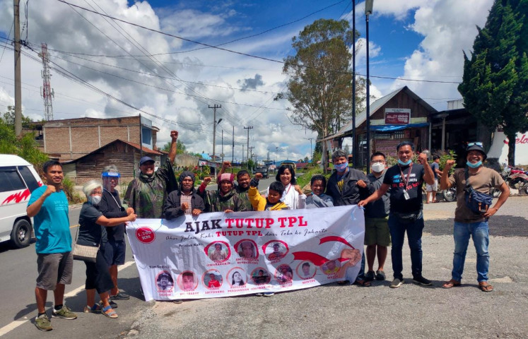 Battling Goliath: Environmental activist Togu Simorangkir (fourth right) and other activists hold up a banner calling for the closure of PT Toba Pulp Lestari operations on customary Batak lands in North Sumatra.