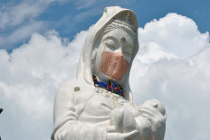 Giant Buddhist goddess in Japan gets face mask to pray for end of COVID-19