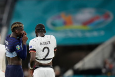 France's midfielder Paul Pogba (L) speaks with Germany's defender Antonio Ruediger during the UEFA EURO 2020 Group F football match between France and Germany at the Allianz Arena in Munich on June 15, 2021.
