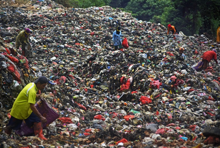 Trashed: Waste pickers sift through a pile of garbage on May 20 at the Cilowong dump site in Serang, Banten. Despite playing an important role in the circular economy, waste pickers are mostly ignored and unprotected. 