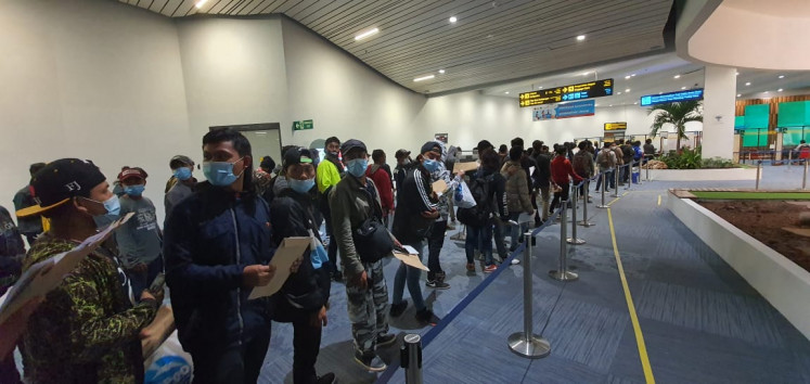 Indonesian seafarers line up for immigration clearance following their arrival at Soekarno-Hatta International Airport in Tangerang, Banten, on June 16, 2021.