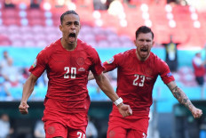 Denmark's forward Yussuf Poulsen (left) celebrates with teammates after scoring the team's first goal during the UEFA EURO 2020 Group B football match between Denmark and Belgium at the Parken Stadium in Copenhagen on June 17, 2021.