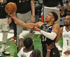 Giannis Antetokounmpo #34 of the Milwaukee Bucks shoots over Jeff Green #8 of the Brooklyn Nets at Fiserv Forum on June 17, 2021 in Milwaukee, Wisconsin. The Bucks defeated the Nets 104-89.