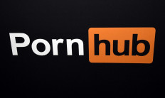 In this file photo taken on January 24, 2018 a Pornhub logo is displayed at the 2018 AVN Adult Entertainment Expo in Las Vegas, Nevada. A complaint was filed on June 17, 2021 in California by 34 women who accuse the website Pornhub and its parent company of having knowingly put online sexual abuse videos.